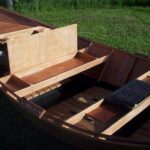 Handcrafted wooden drift boat interior layout with custom storage boxes built in Missoula, Montana.